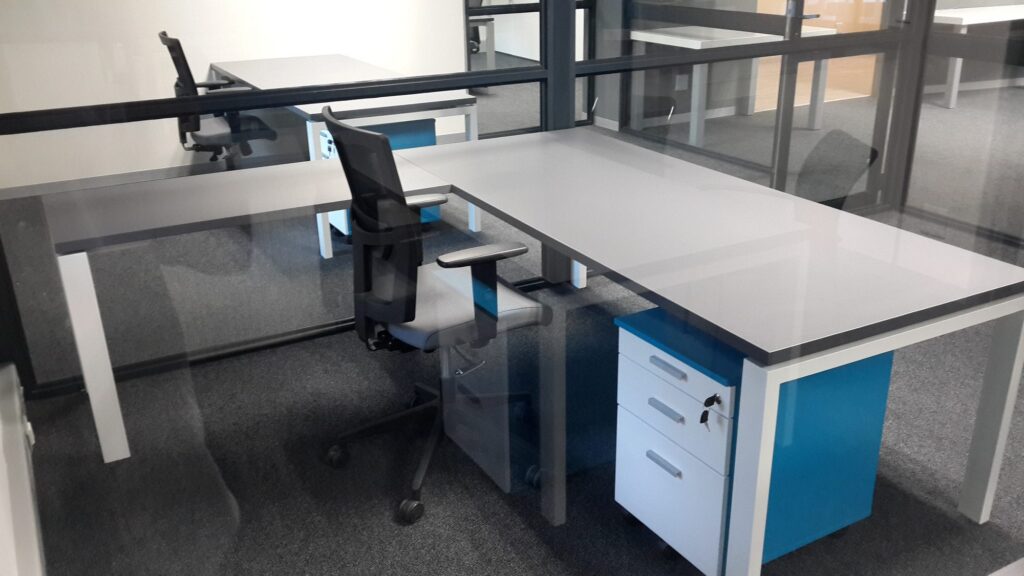 Workstations with blue pedestals and task chairs at Camel Fuel in Cape Town, furnished by Nuwave