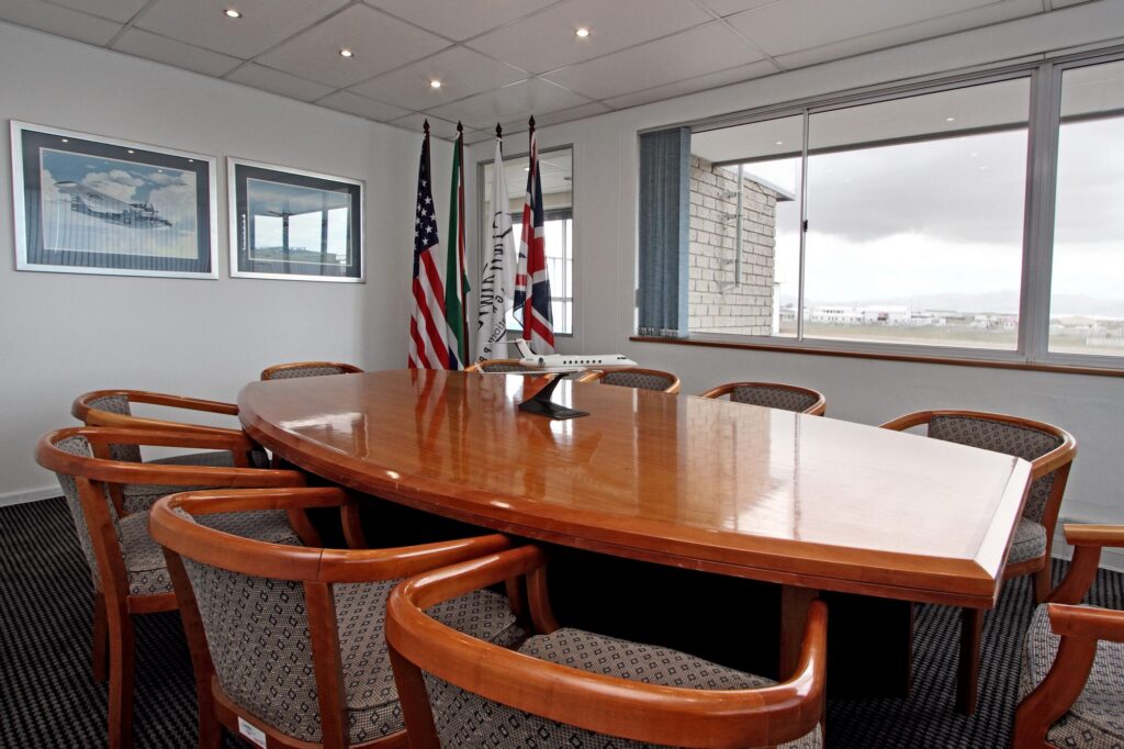 The boardroom timber table and chairs with flags at Signature Flight Support, Cape Town Airport, by Nuwave