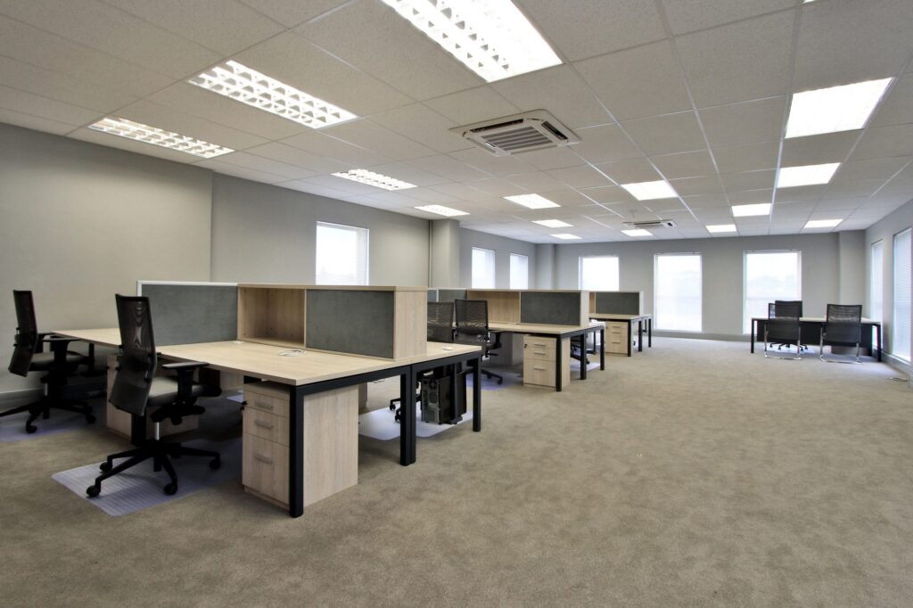 Open plan workstations with fabric screens and mesh back chairs at New Approach Medical, by Nuwave