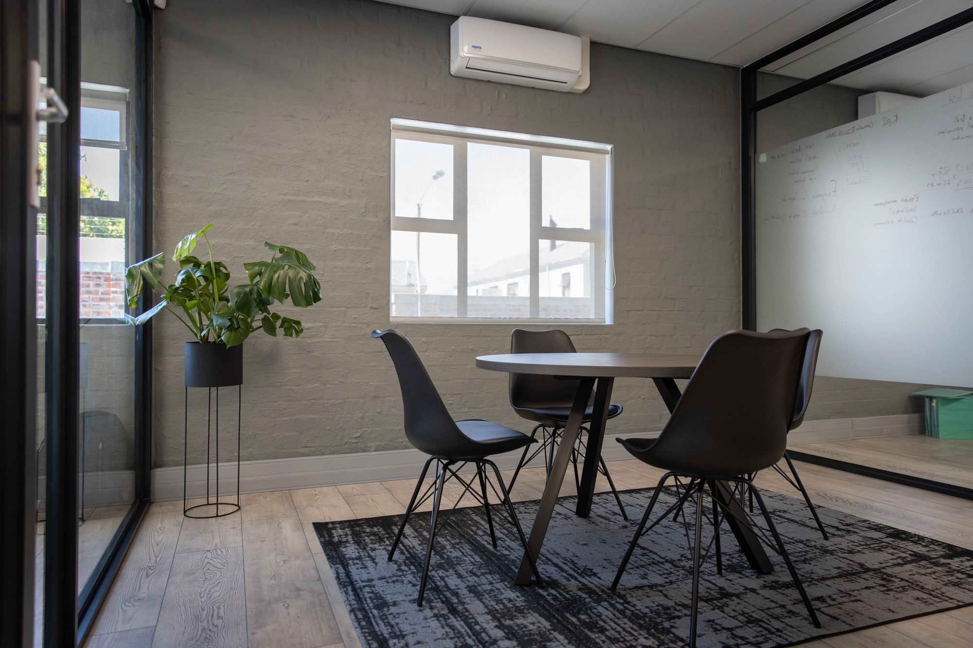 A meeting room table with chairs and a plant at Vancula Agency in Cape Town, by Nuwave