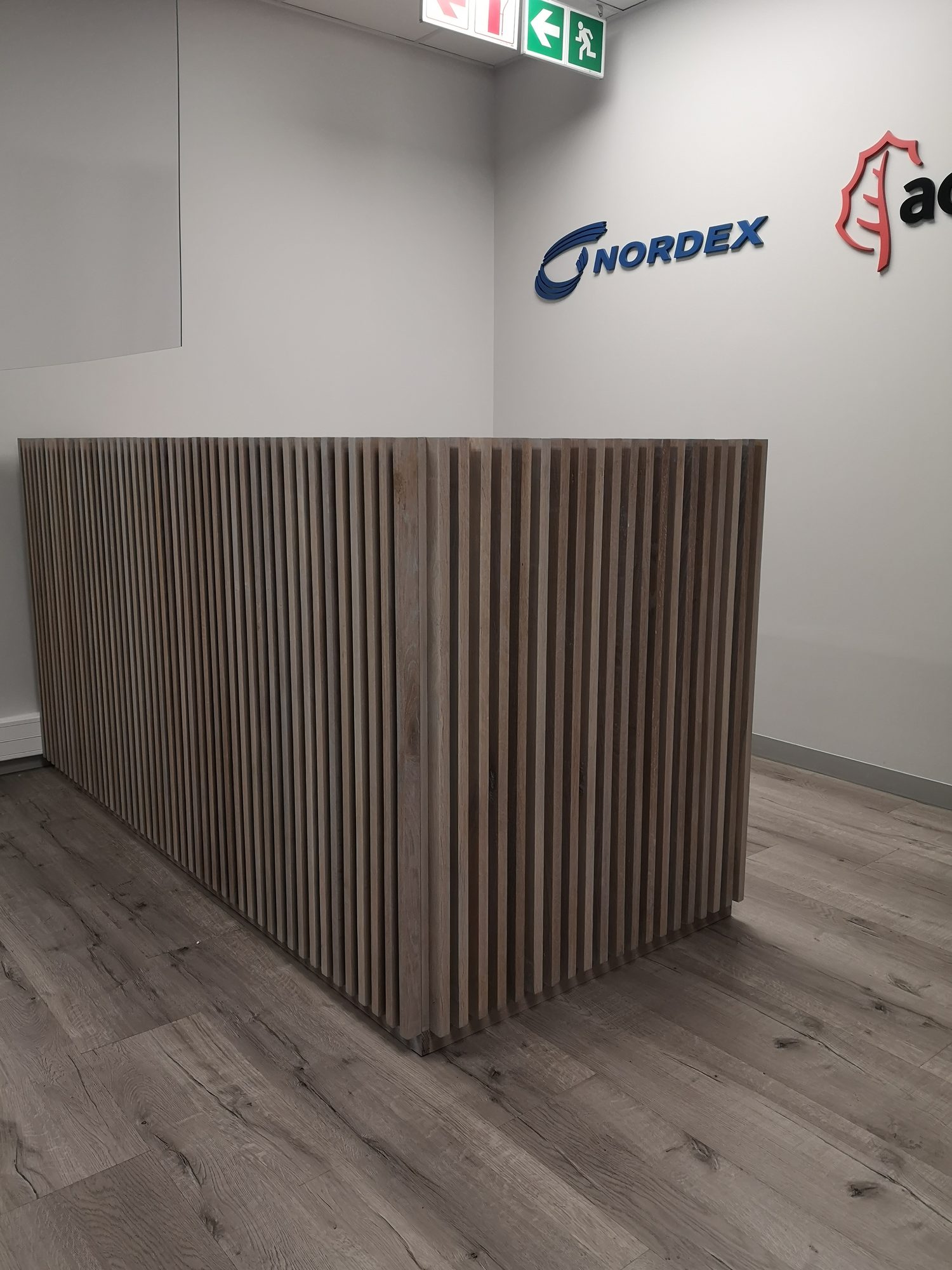 The slatted timber reception counter with the Nordex logo at Nordex Energy in Cape Town, by Nuwave
