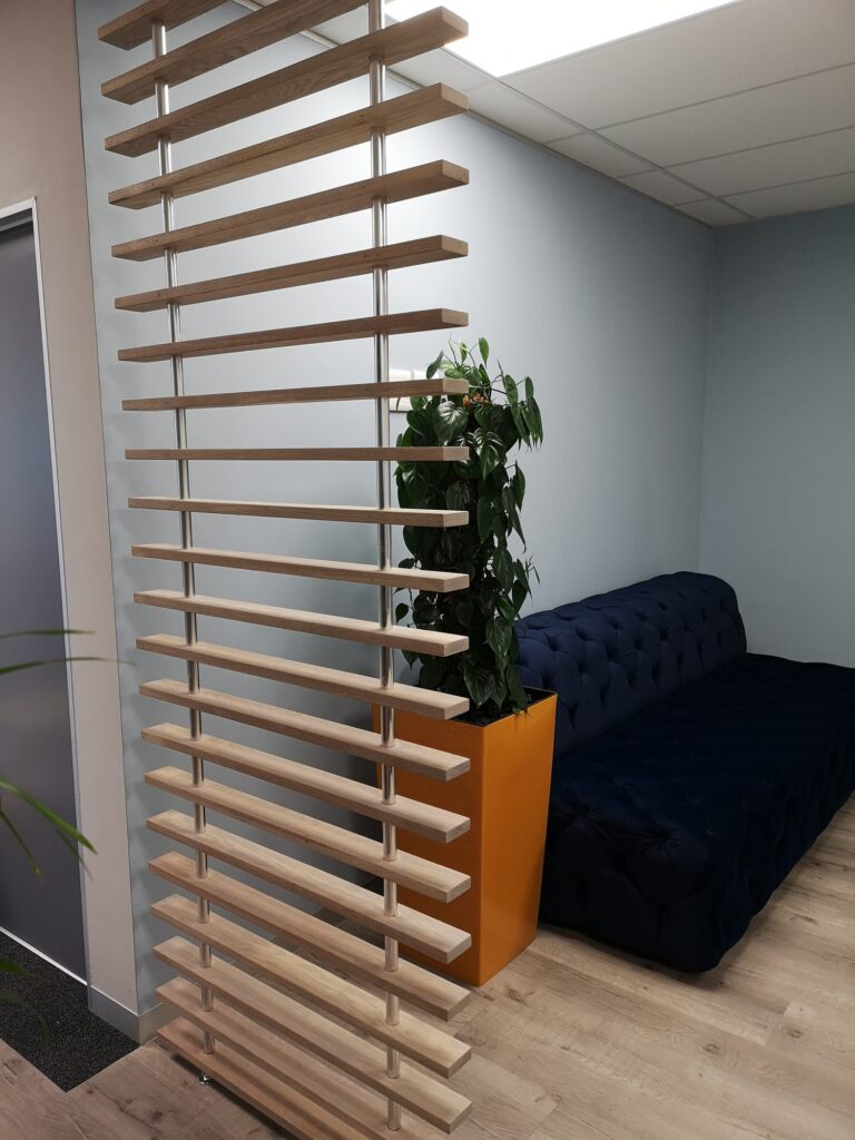 A timber slat screen, blue sofa and orange planter at Nordex Energy in Cape Town, by Nuwave