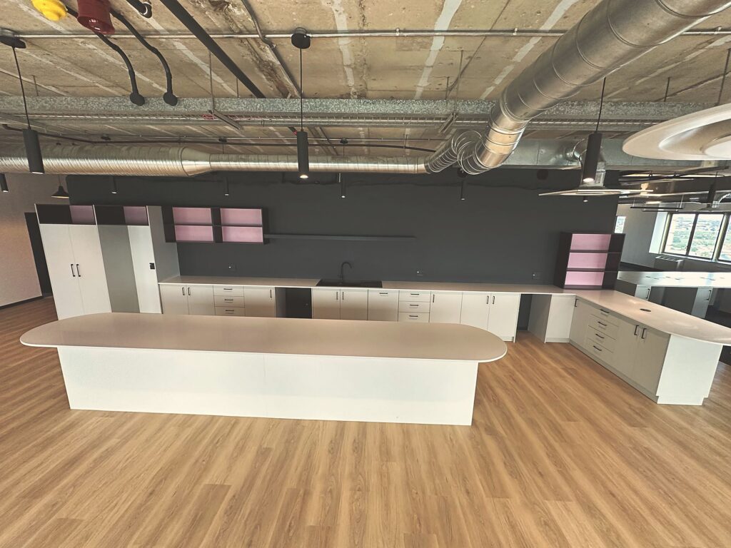 The long kitchen island and white joinery at Polycat Visual Effects, built by Nuwave
