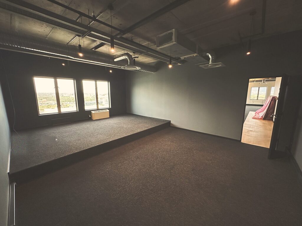 A black walled room with a raised platform at Polycat Visual Effects, by Nuwave
