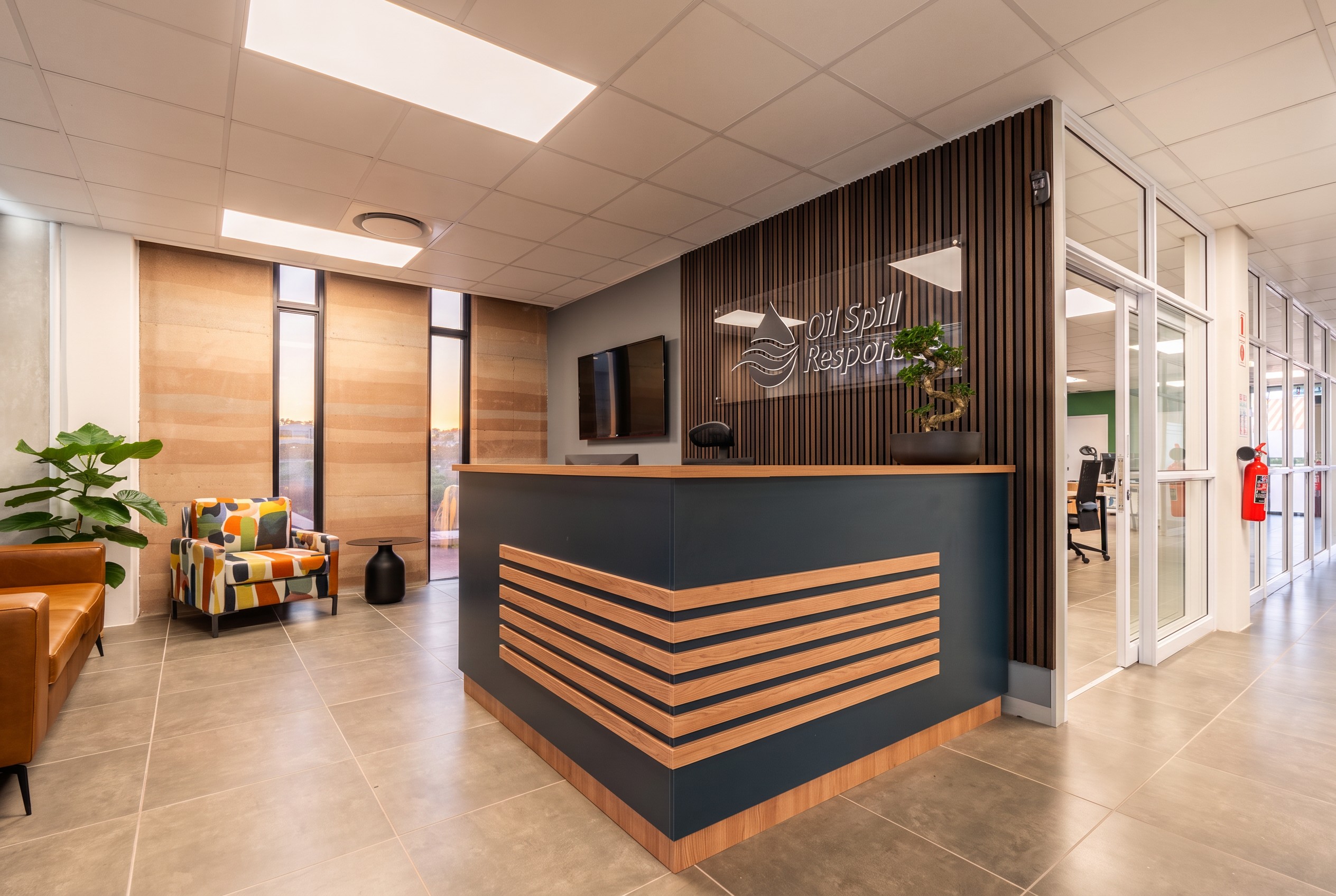 The navy and timber reception counter under the Oil Spill Response logo, installed by Nuwave