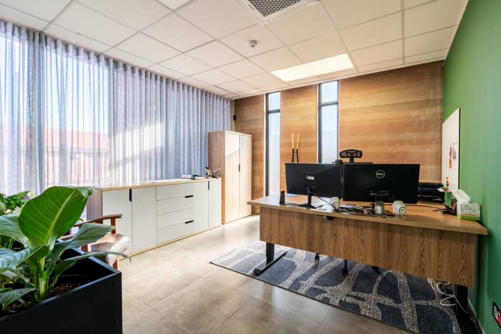 A private office with a sit stand desk and white storage at Oil Spill Response, by Nuwave