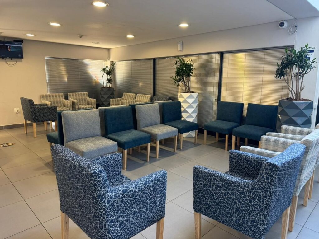 Waiting room armchairs in blue and patterned fabric at Cure Day Hospital in Bellville, furnished by Nuwave