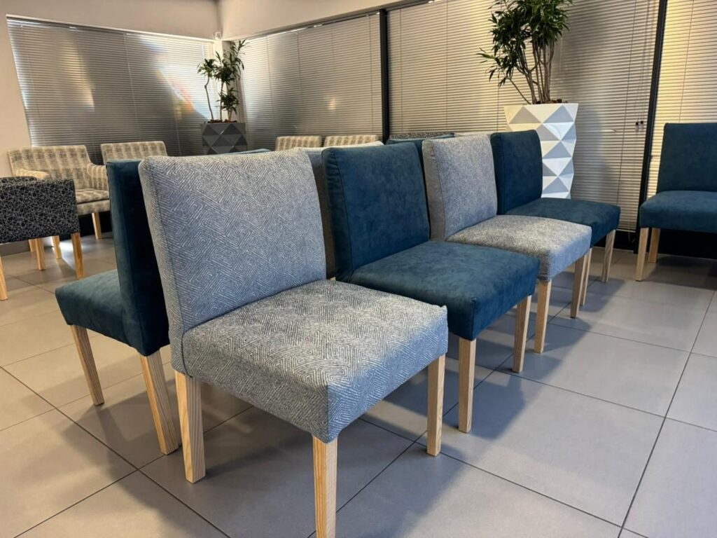 Waiting room armchairs around a low table at Cure Day Hospital in Bellville, by Nuwave