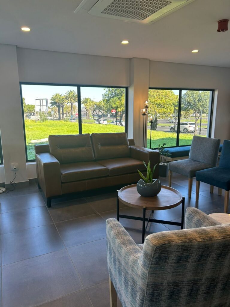 A coffee corner lounge and side table by the window at Cure Day Hospital in Bellville, by Nuwave
