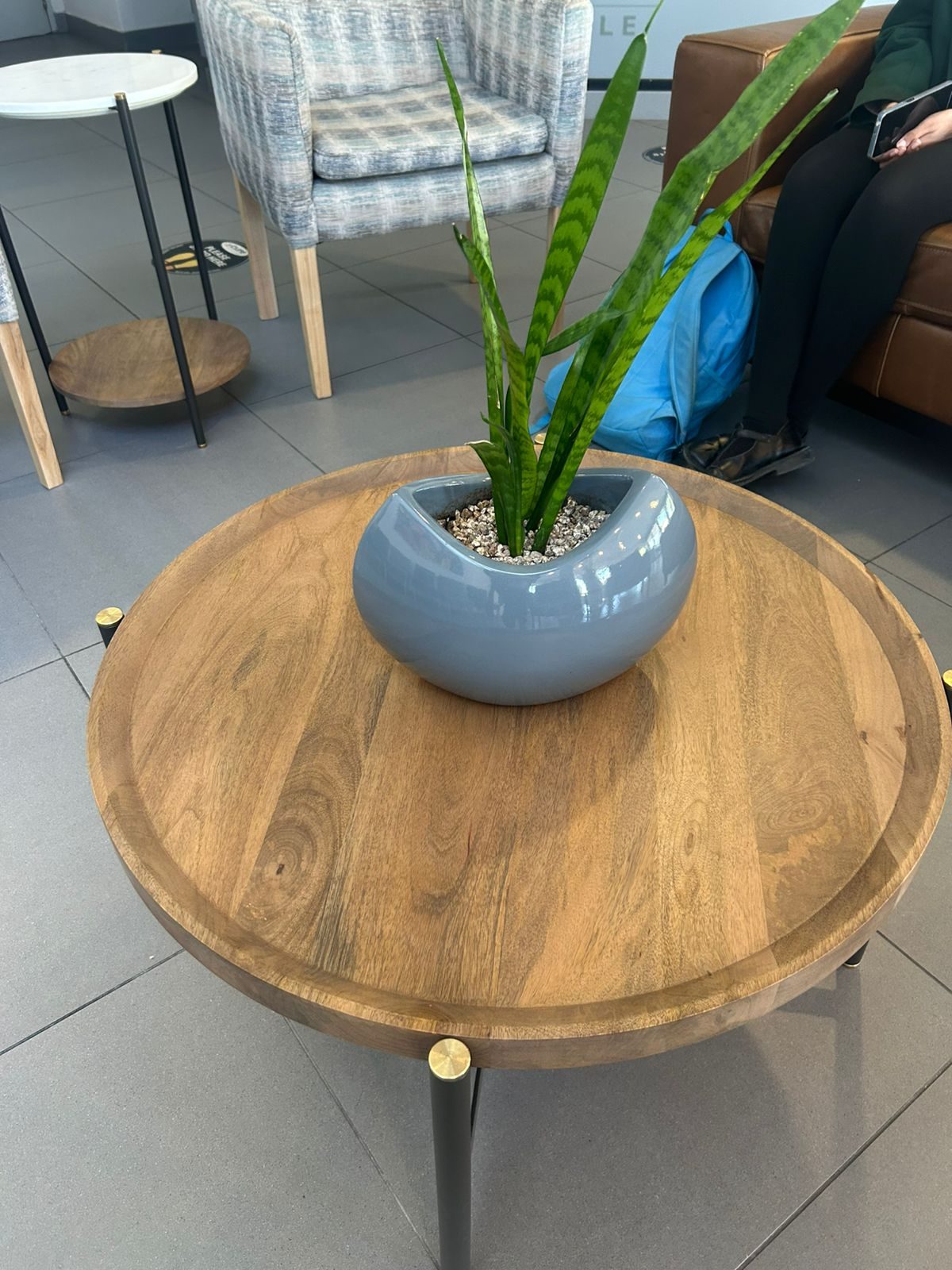 A round side table with a plant between the waiting seats at Cure Day Hospital, Bellville, by Nuwave