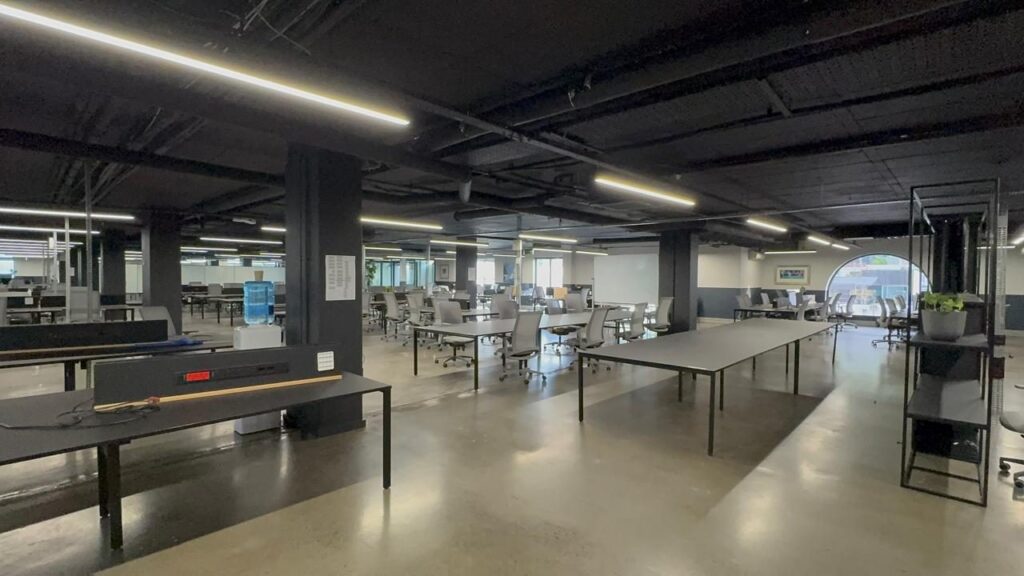 Open plan workstation runs with mesh back task chairs at Rain's Cape Town office, furnished by Nuwave