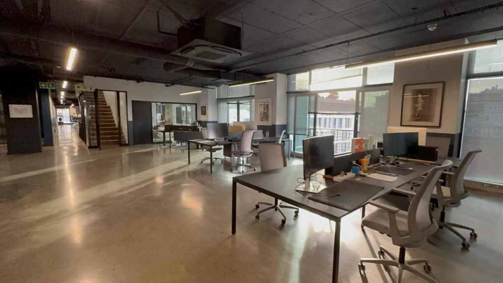 A long desking run with task chairs down Rain's open plan office in Cape Town, by Nuwave