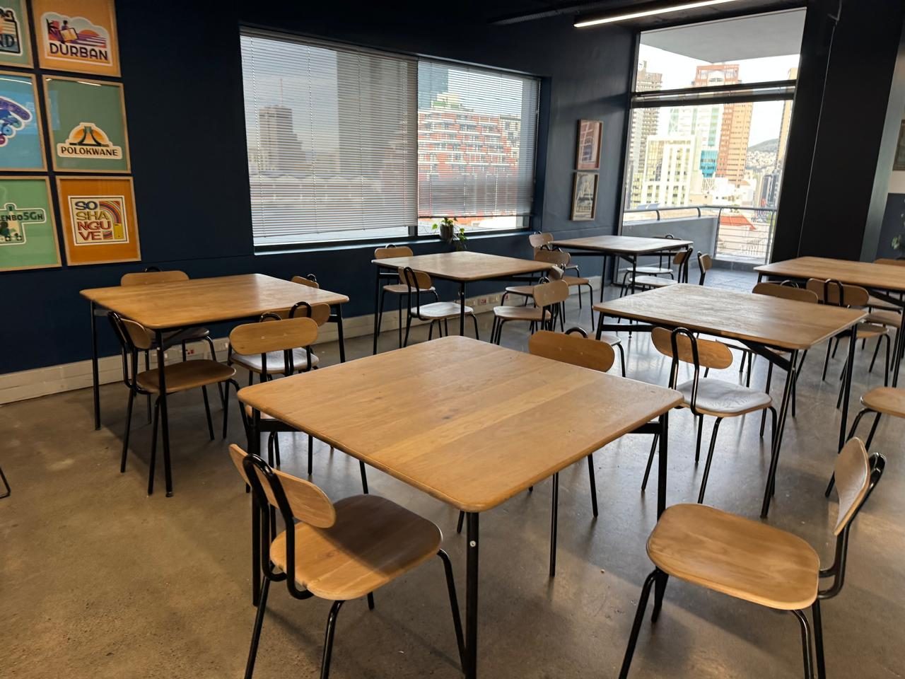 A timber canteen table with chairs in the Rain office in Cape Town, furnished by Nuwave