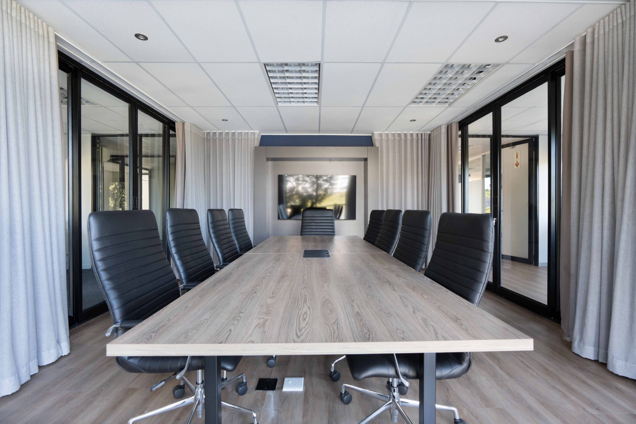 Completed office fit out with glass partitioned meeting rooms and workstations