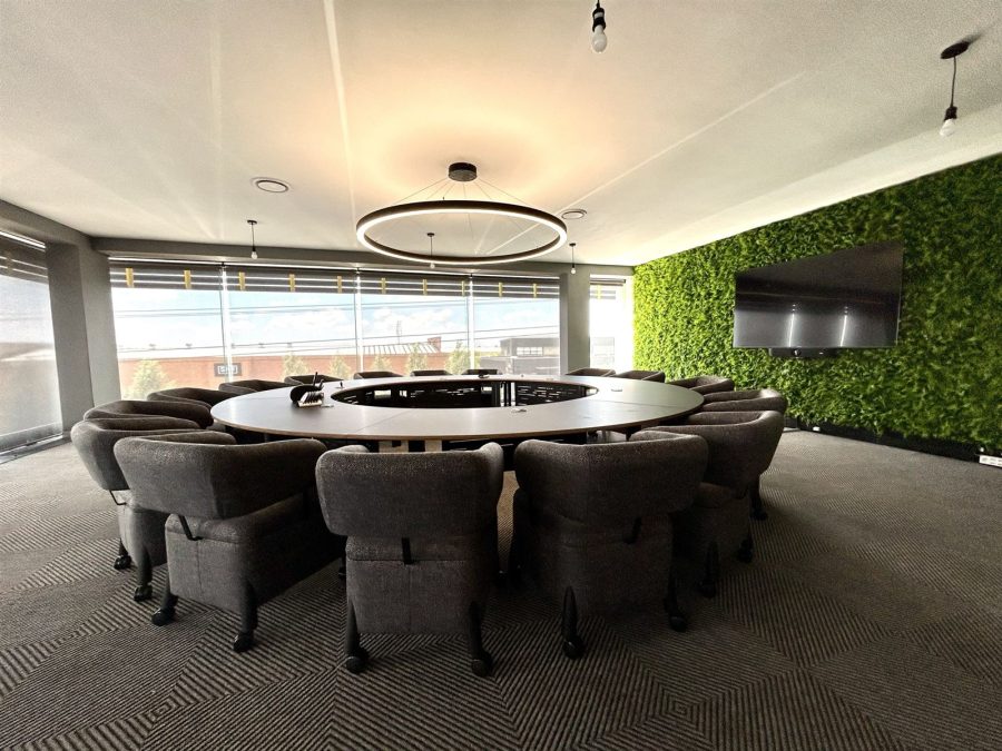 Boardroom with round table and living green wall